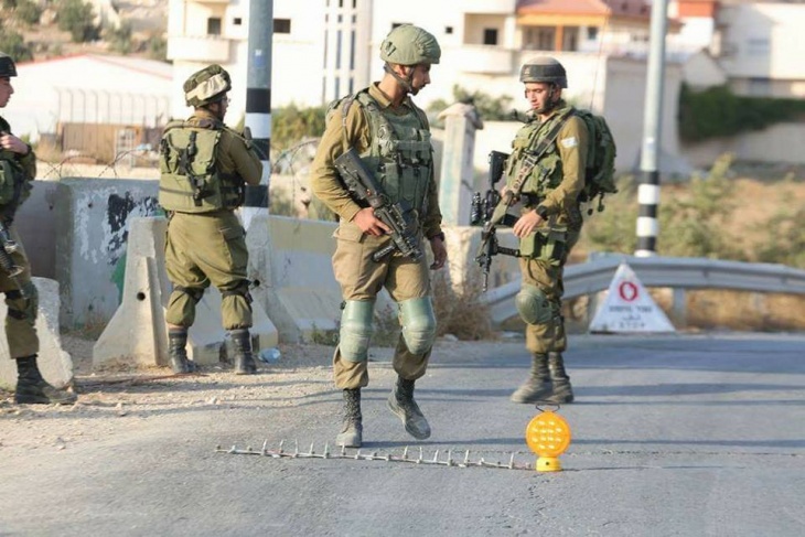 The occupation arrests a young man at a military checkpoint south of Jericho